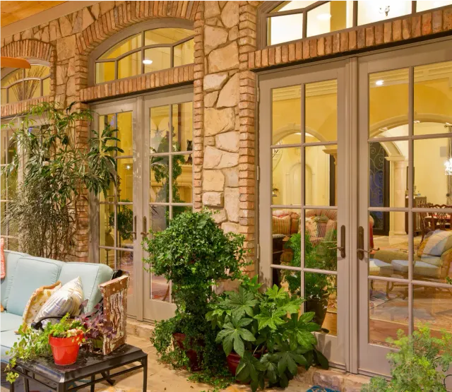 A series of renovated patio doors on a stone home
