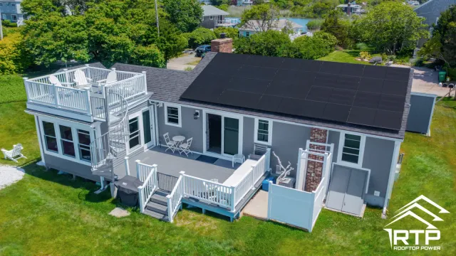 Residential home with solar panels and deck illustrating Rhode Island solar incentives.