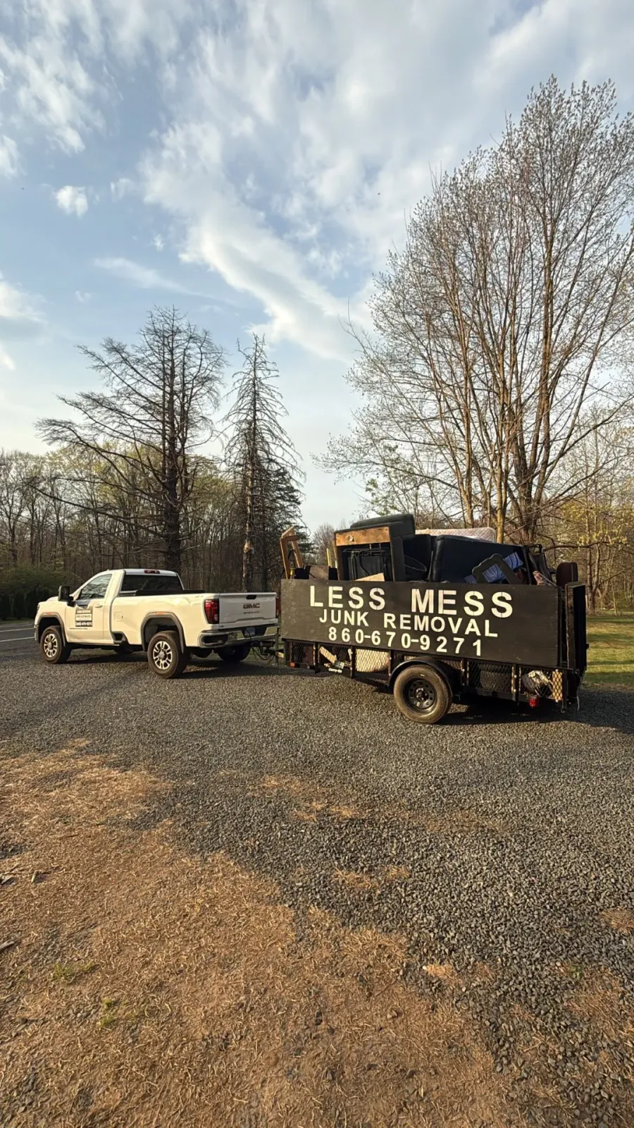 White pickup truck towing a black trailer labeled