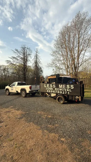 White pickup truck towing a black trailer labeled