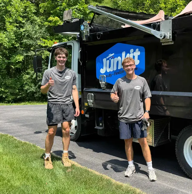Junkit team members standing by truck after finishing a job in Shelburne