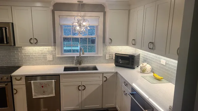 Completed kitchen with white shaker cabinetry and tile backsplash