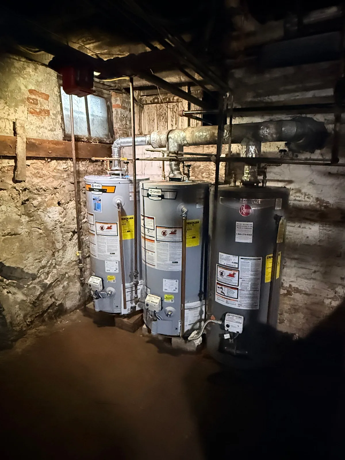 Multiple gas water heaters installed in a basement