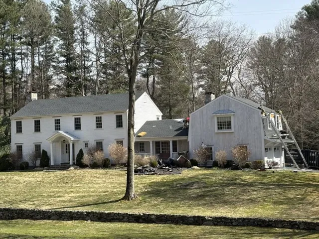 Colonial home and attached barn with a new asphalt shingle roof by Fulcrum Contracting