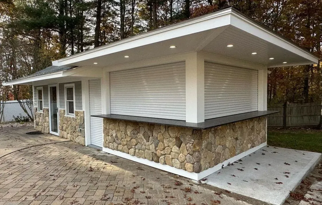 A small building with a stone wall