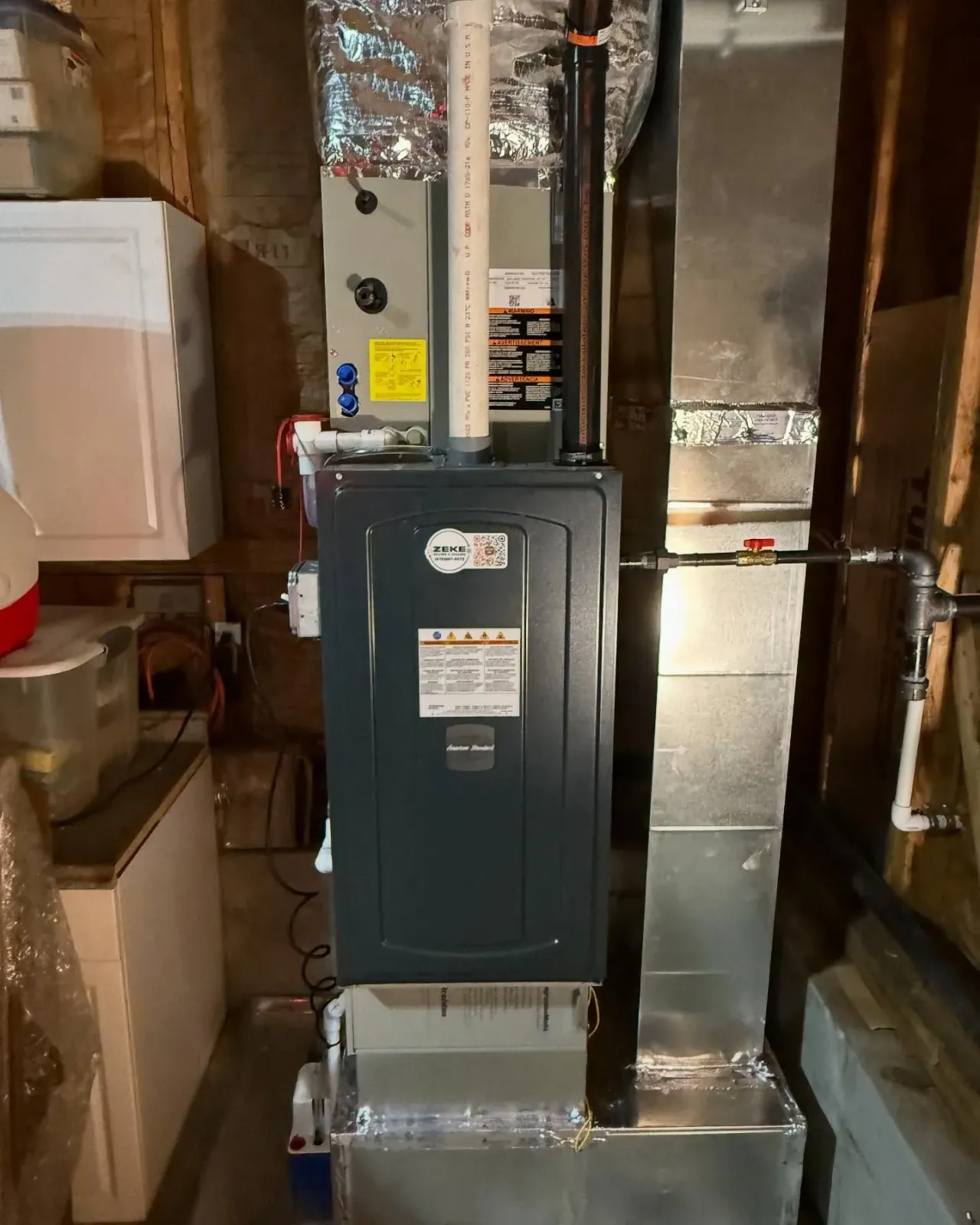 A heating and cooling system is installed in a basement.