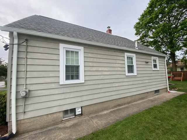 small light gray house with dark gray roof