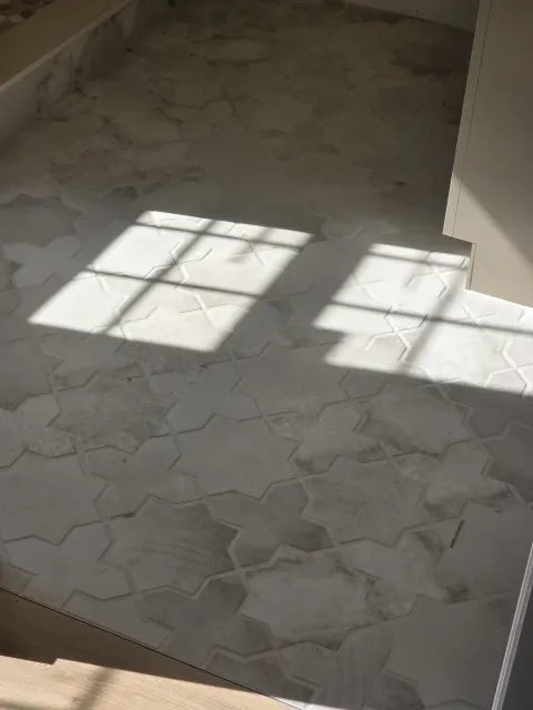 Close view of irregular-pattern tile installed on a shower wall