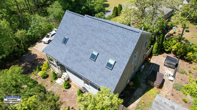 Aerial gable-end view of the Harwich, MA Cape showing Velux skylights set in a row down the new Coastal Blue Landmark Pro roof slope