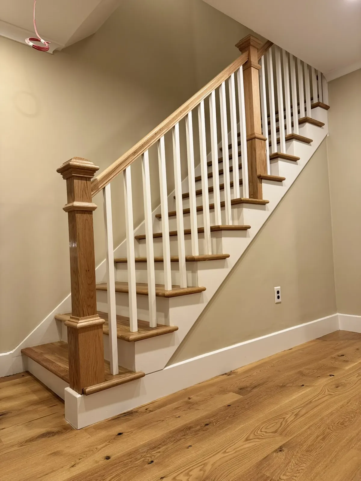 Finished staircase rising against a plain wall