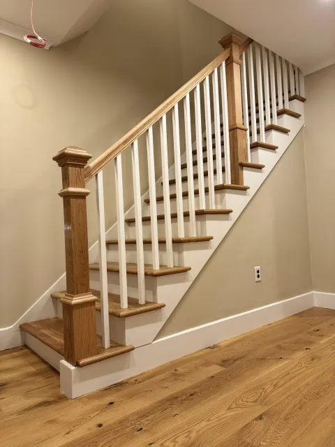 Finished staircase rising against a plain wall