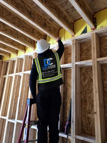 DryCore worker preparing a residential building for caulking