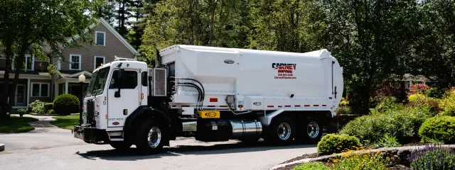 Carney Disposal trash truck on a residential street in southeastern Massachusetts