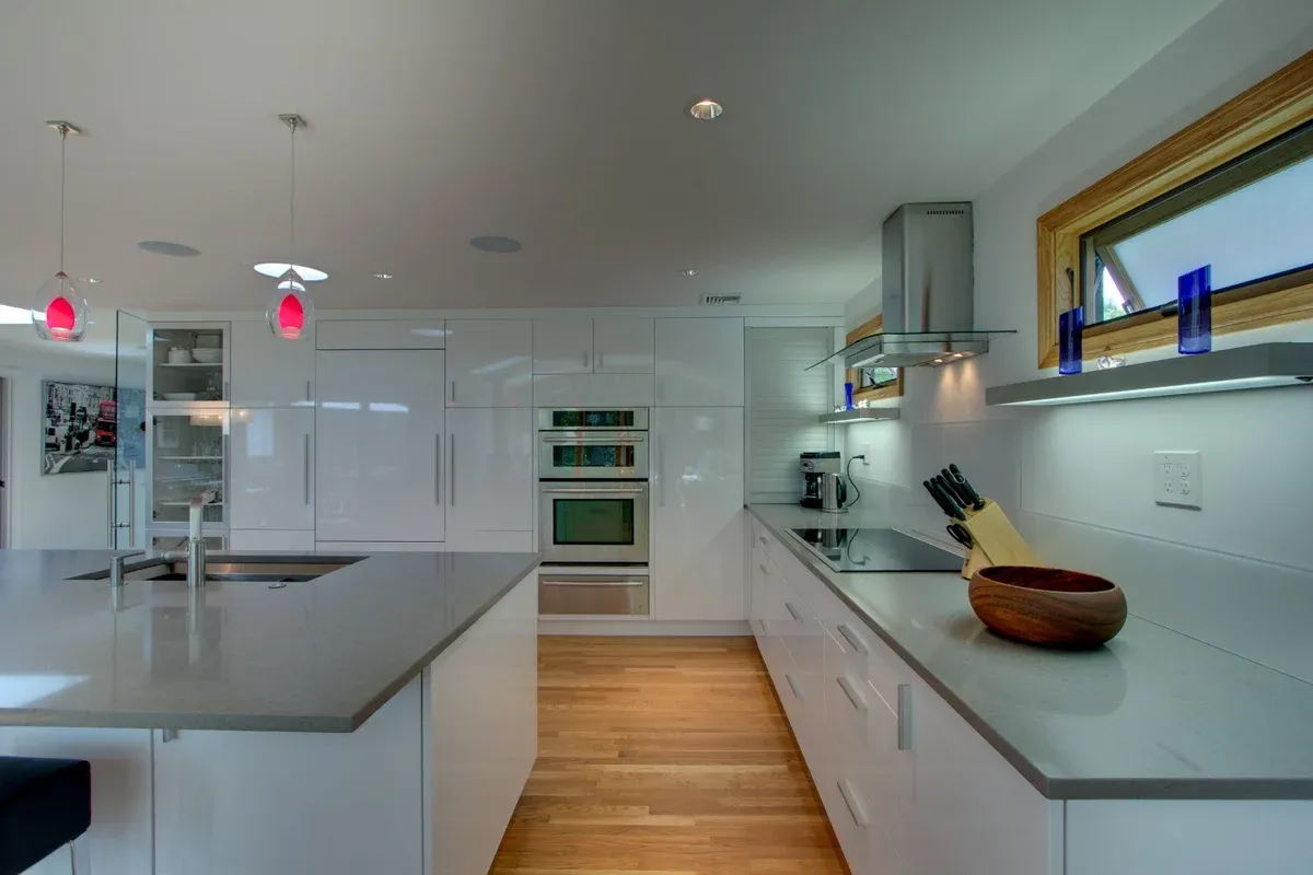 updated kitchen design with minimalist cabinets and wood flooring by PEGASUS Design-to-Build in Arlington, MA-optimized