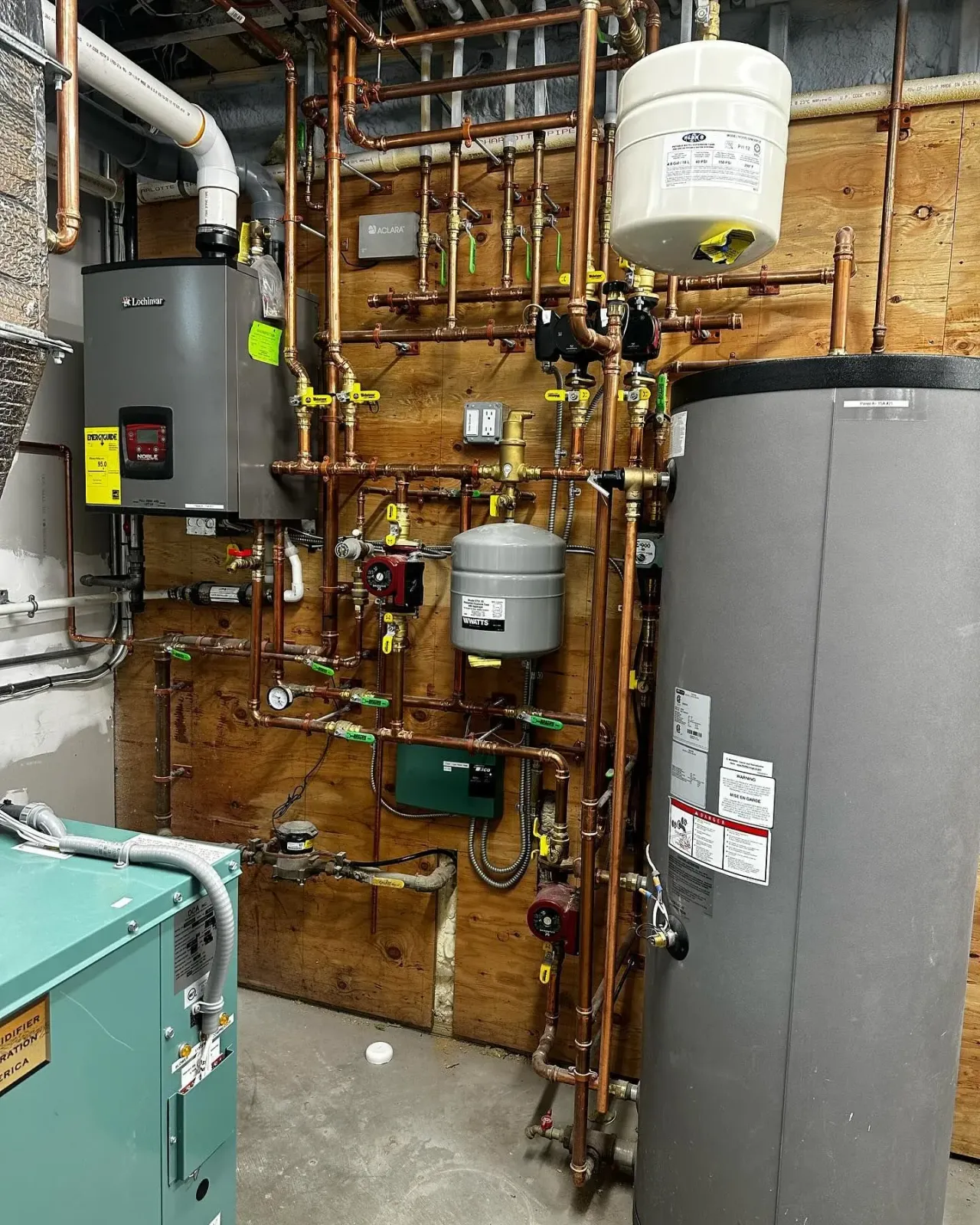 a room filled with lots of pipes and a water heater
