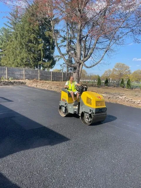 A man is riding a yellow roller on a road.