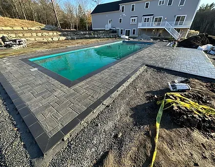 Newly installed paver pool deck for a residential pool construction in Acton, MA