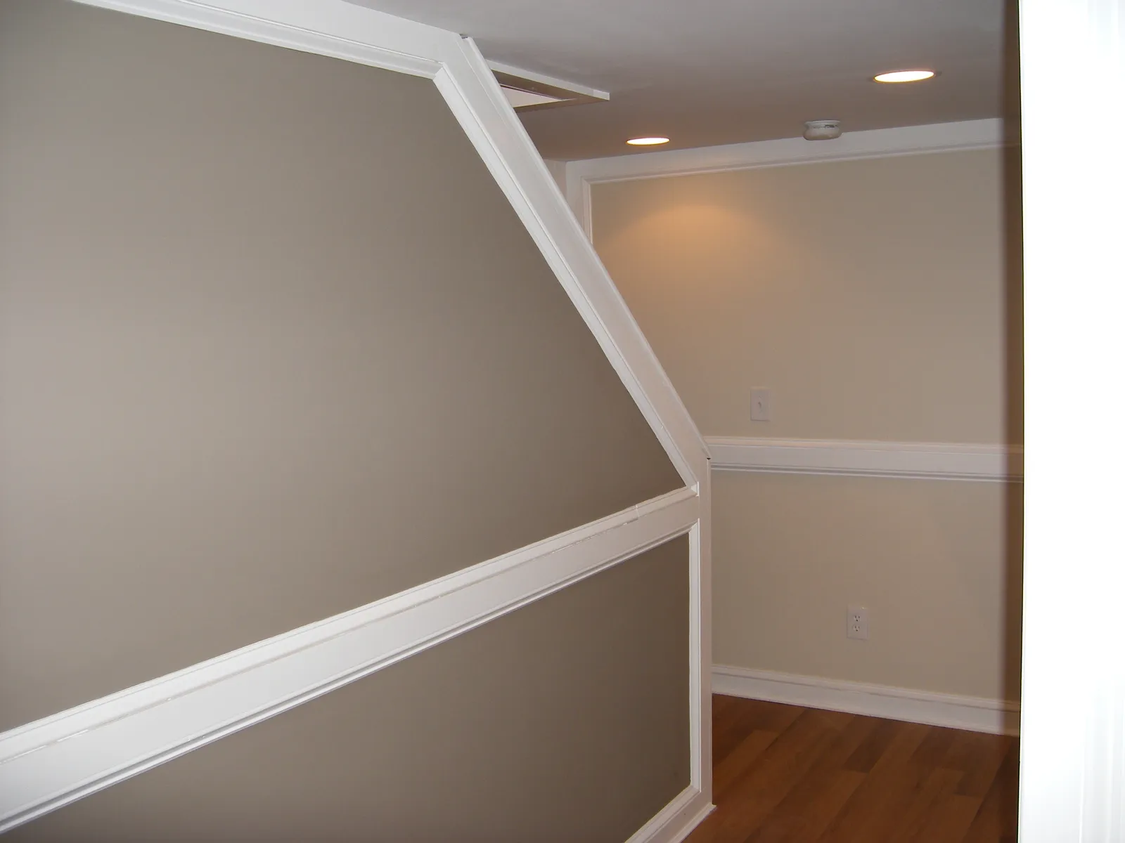 Finished room with sloped ceiling, wainscoting and new trim