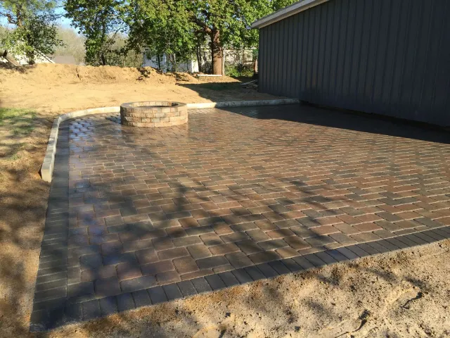There is a fire pit in the middle of the patio.