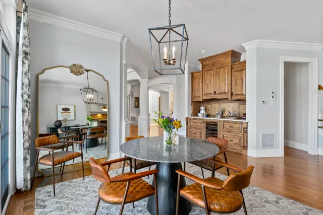 Kitchen breakfast table with warm leather furniture and cabinetry