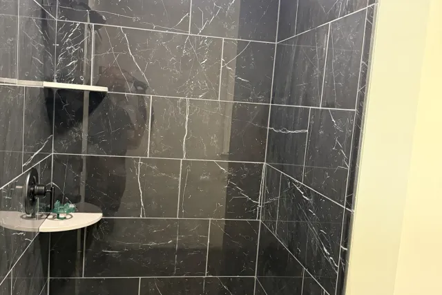 Black Marble-Look Walk-In Shower tile installation in Berlin, CT by Dmtilellc