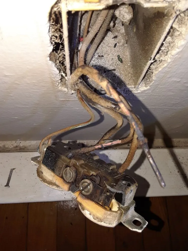 Burned-out receptacle removed during a repair