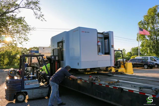 A brake press loaded onto a single drop flatbed trailer