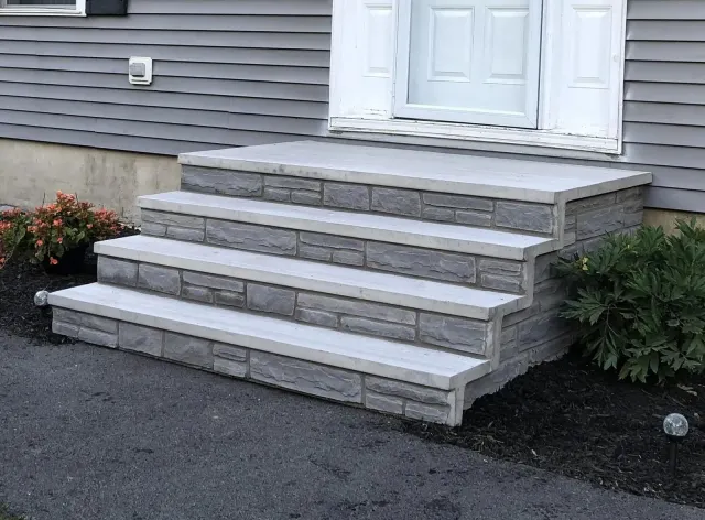 A set of stairs leading up to the front door of a house.