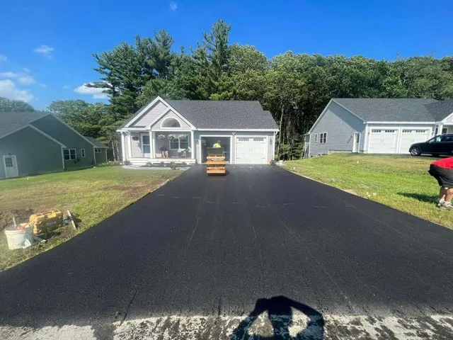 Asphalt driveway installation in residential neighborhood