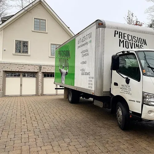 Moving truck parked in front of a house. White truck with