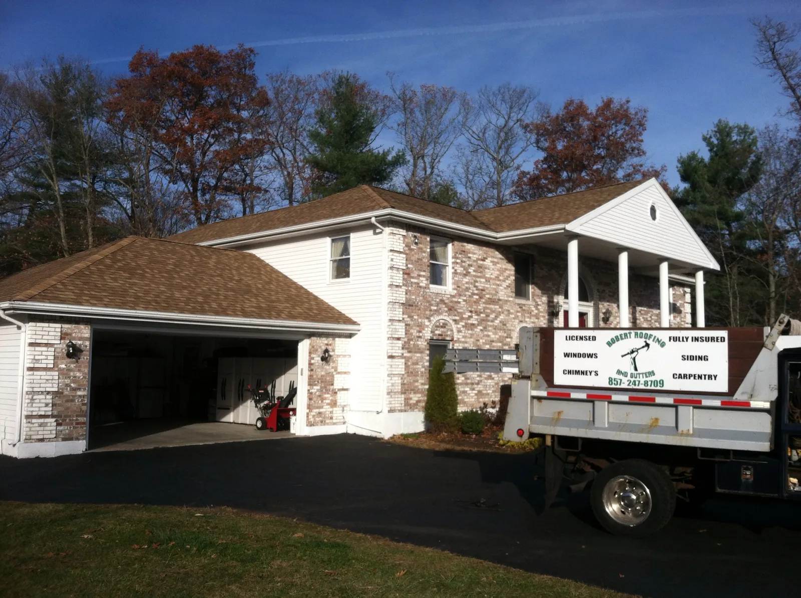 Completed roof with the company's branded truck on site