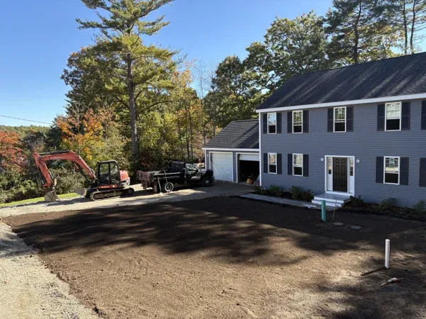 Excavation equipment preparing residential property for patio installation by MAC Excavation & Landscape in South Shore MA