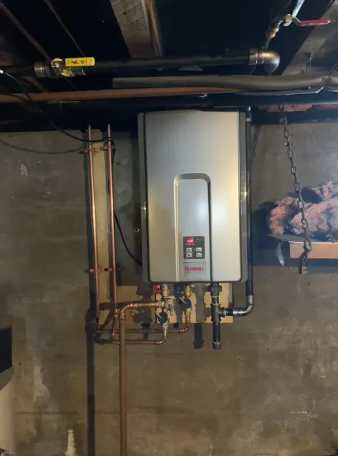 A water heater is hanging from the ceiling in a basement.
