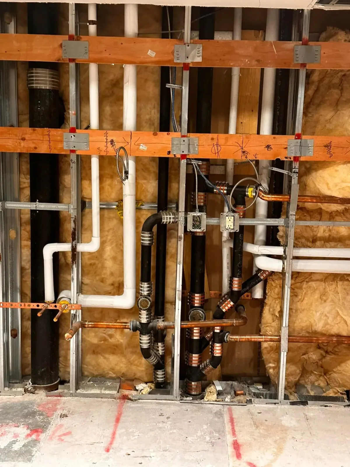 A wall with a lot of pipes in it
