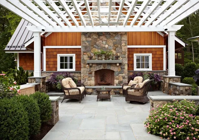 Image of an outdoor living space with pergola and fireplace by TR Design-Build
