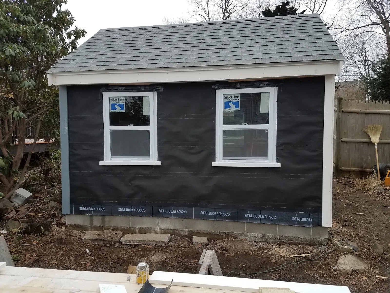 Pool house framed and sheathed with new windows