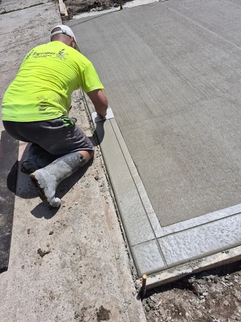 Kingscapes craftsman hand-finishing the edge of a concrete surface