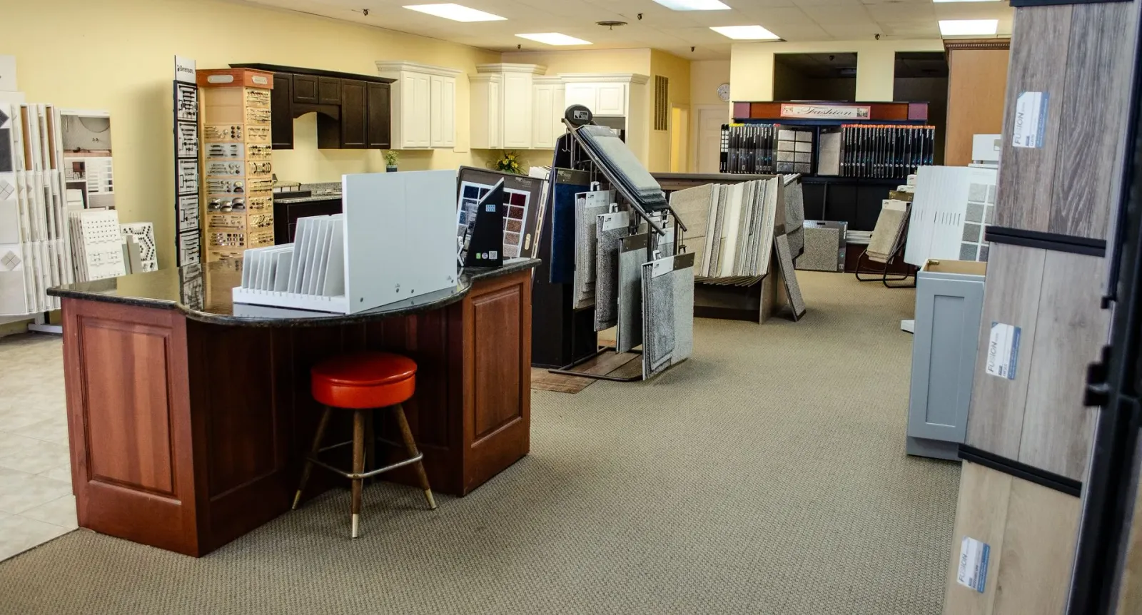 a large room with a desk and a stool in it