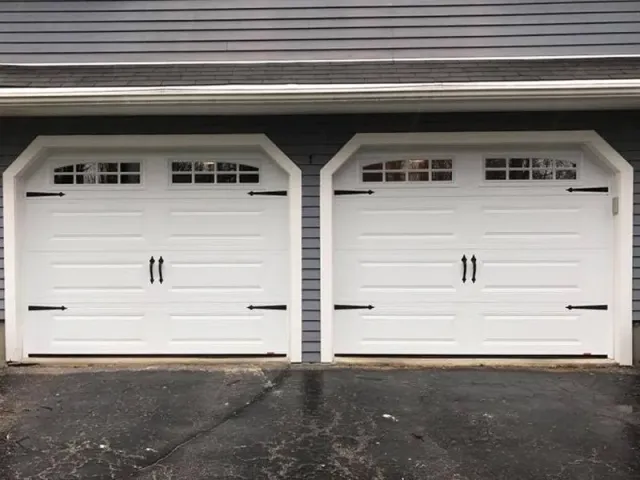 A pair of white garage doors sitting next to each other