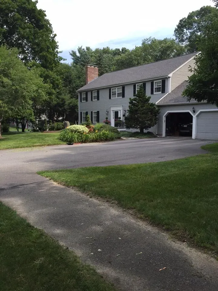 A large white house with a garage and a driveway