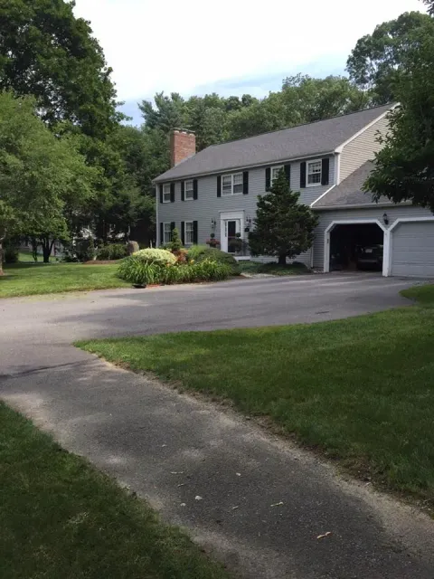 A large white house with a garage and a driveway