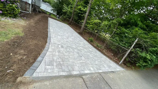 Compacted base prep before paver installation in Massachusetts