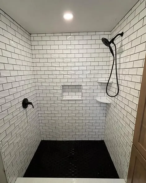 Subway-tiled shower with black fixtures