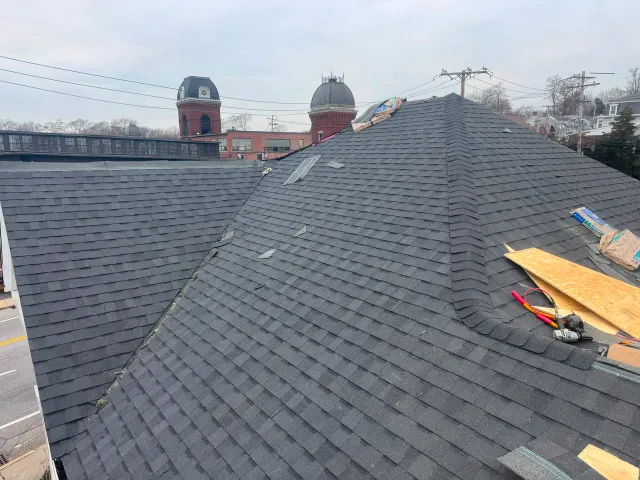 Roofing crew working on a pitched roof
