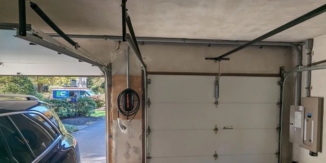 Garage EV charging station install with the NEC van outside