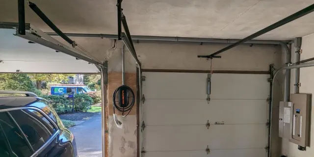 Garage EV charging station install with the NEC van outside