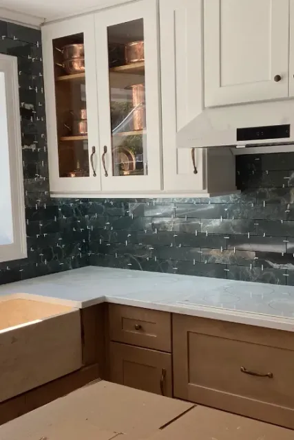 Two-tone kitchen with white upper and walnut lower cabinets, marble counter and green by SF Construction in Southborough, MA