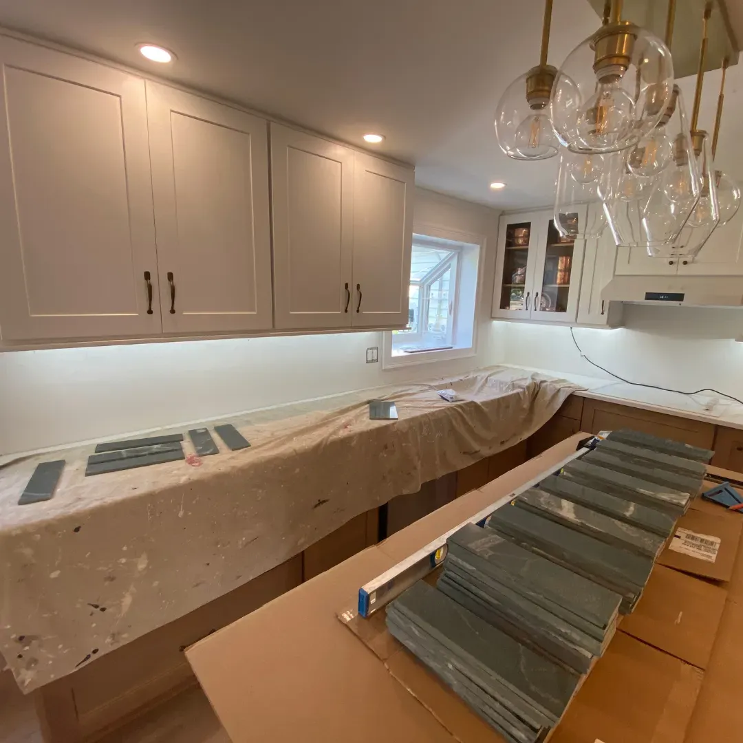 Custom kitchen remodel in progress with walnut cabinets, white uppers and brass globe by SF Construction in Northborough, MA