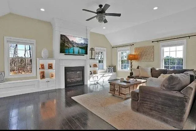 Built in bookshelves around a custome fireplace with bench seats in Plymouth MA by Freeland woodworks
