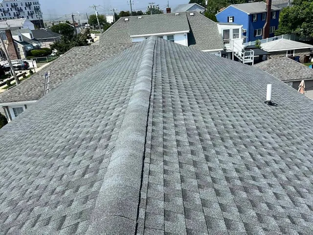 New shingles along a replaced roof ridge